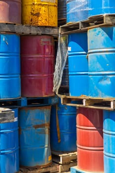 Rows of stacked steel barrels of various colors