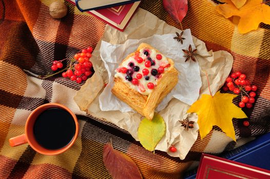 Romantic autumn still life with blanket, cake, book, coffee cups and leaves, top view