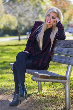 A blonde model posing in an outdoor environment