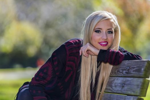 A blonde model posing in an outdoor environment