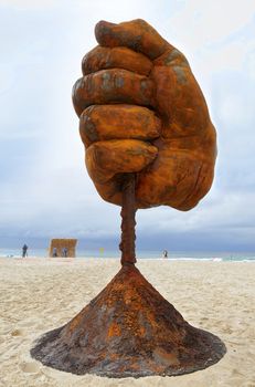 BONDI, AUSTRALIA - OCTOBER 22, 2015;  Annual Sculpture by the Sea free public event.  Exhibit titled  Dust by Norton Flavel.  Weathered steel fist.