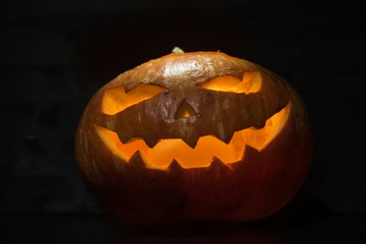 Halloween pumpkin with scary face on black backgound