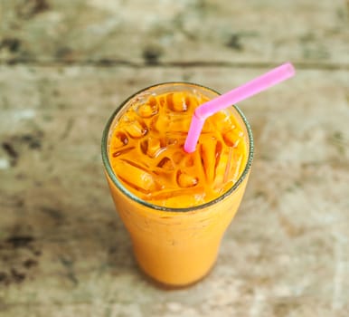 Ice milk tea, famous drink on old wood table, Grunge background