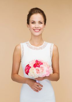 happiness, wedding, holidays and celebration concept - smiling bride or bridesmaid in white dress with bouquet of flowers