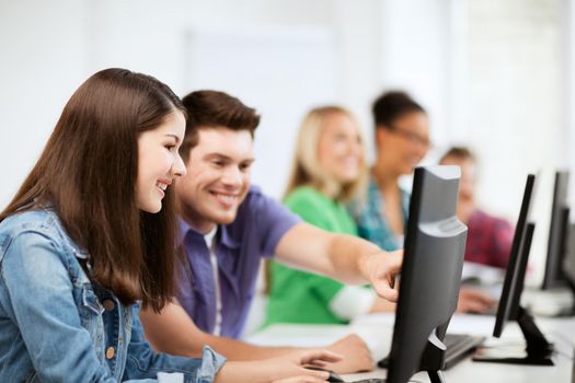 education, technology and internet - students with computers studying at school