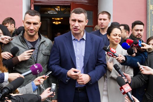 UKRAINE, Kiev: Kiev's mayor Vitaly Klitschko, his wife Natalia, and brother Vladimir Klitschko prepare to cast their ballots at a polling station in Kiev on October 25, 2015. Ukrainians are voting in local elections to choose mayors and representatives to municipal councils in all parts of Ukraine except eastern areas controlled by Russian-backed separatists and in Russian-annexed Crimea. Polling stations are open across all Kiev-administered regions except for Mariupol. 