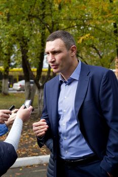 UKRAINE, Kiev: Kiev's mayor Vitaly Klitschko, his wife Natalia, and brother Vladimir Klitschko prepare to cast their ballots at a polling station in Kiev on October 25, 2015. Ukrainians are voting in local elections to choose mayors and representatives to municipal councils in all parts of Ukraine except eastern areas controlled by Russian-backed separatists and in Russian-annexed Crimea. Polling stations are open across all Kiev-administered regions except for Mariupol. 