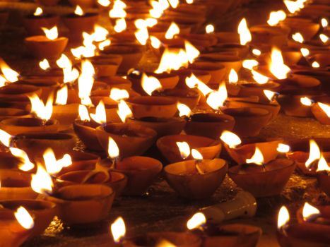 Traditional oil lamps in earthen pot lit up on the festive occasion of Diwali in India.                               