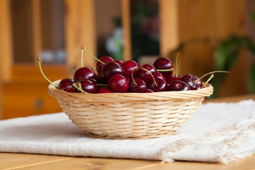 Cherries on wooden table, outdoor