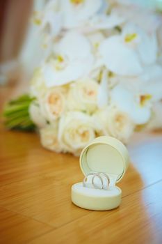 The wedding bouquet and silver rings. Shallow DOF