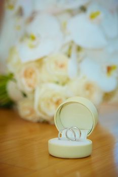 The wedding bouquet and silver rings. Shallow DOF