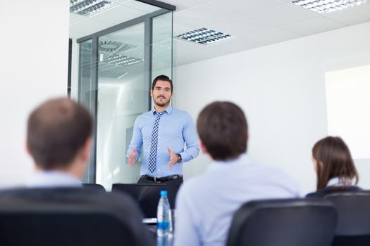 Business man making a presentation in office on job interview. Business presentation on corporate meeting. Recruiters evaluating the candidate. 