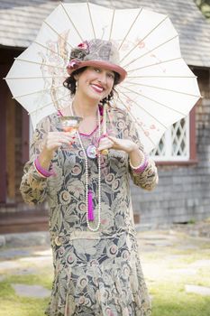 Beautiful 1920s Dressed Girl with Parasol and Glass of Wine Portrait.