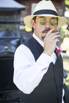 Handsome 1920s Dressed Man Near Vintage Car Smoking A Cigar.