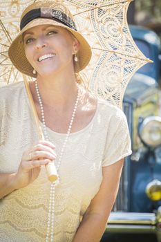 Beautiful 1920s Dressed Girl with Parasol Near Vintage Car Portrait.