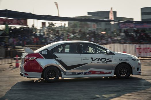 Udon Thani, Thailand - October 18, 2015: Toyota Vios perform drifting on the track at the event Toyota Motor Sport show at Udon Thani, Thailand with motion blur in the background. The car was drive by driver from Toyota teams Thailand
