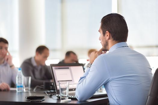 Corporate business meeting in office. Business executive giving instructions to his colleagues. Explaining business plans to employees. Business team concept. Business and Entrepreneurship. 