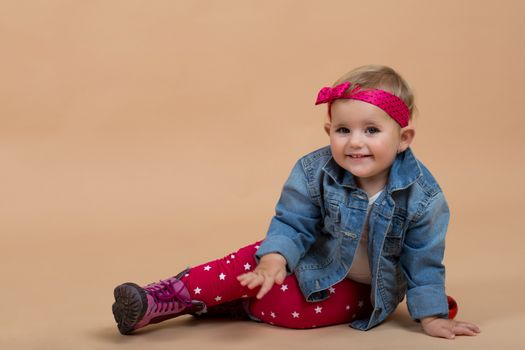 portrait of young cute baby on beige background