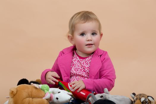 portrait of young cute baby on beige background