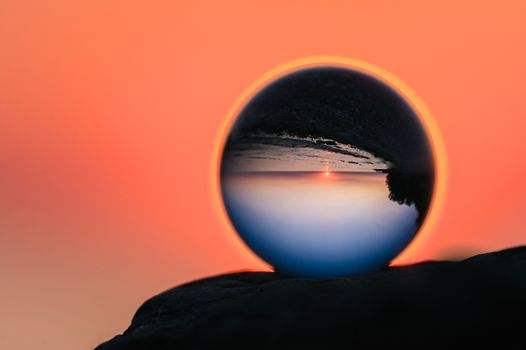 Shore is reflected in the crystal ball in evening
