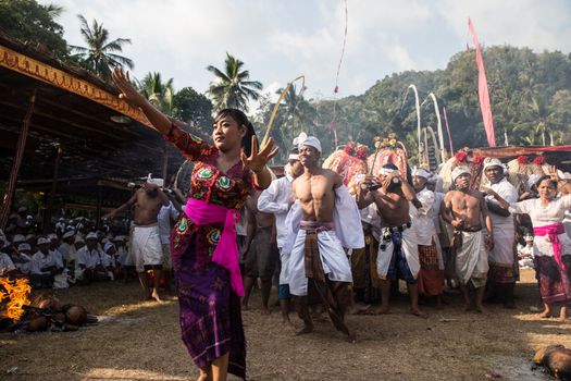 INDONESIA, BALI, Selumbung: A Balinese women in Selumbung village celebrate the sacred Ngusaba Puseh ritual with dance, on September 30, 2015.  The ritual is celebrated with dancing, chanting and fires fueled by burning coconut shells. Participants are typically in a trance-like state, with some individuals entering a trance that is so strong they stab themselves with a ceremonial dagger called a 'keris'.