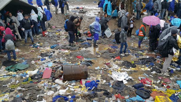 SERBIA, Sid: Refugees gather at a camp in Sid, Serbia on October 19, 2015, where they have been stranded in the cold for nearly two days before the opening of the border with Croatia that day. The area has become increasingly congested with refugees since the weekend, when Hungary closed its borders with Croatia.