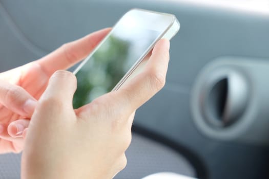 Close up image of woman making a phone call in the car.