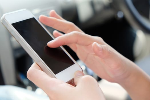 Close up image of woman making a phone call in the car.