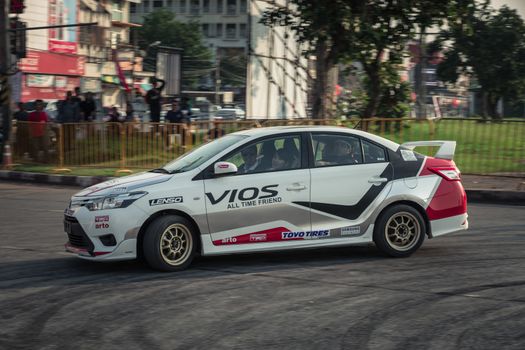 Udon Thani, Thailand - October 18, 2015: Toyota Vios perform drifting on the track at the event Toyota Motor Sport show at Udon Thani, Thailand with motion blur in the background. The car was drive by driver from Toyota teams Thailand