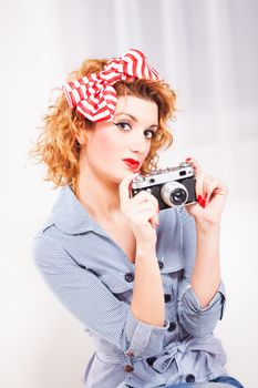 Portrait of elegant retro style woman/housewife with photo camera.