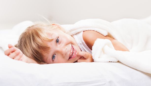 Cute little girl in the bed.