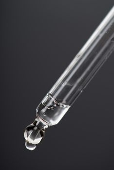 Close-up Dropper with drops Essential liquid.