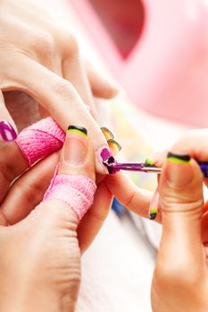 Manicure treatment in cosmetic salon.