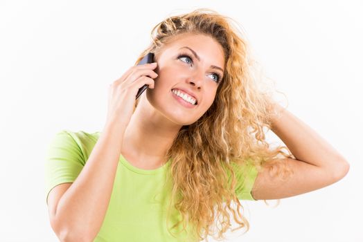 Portrait of a young smiling woman using a cellphone.