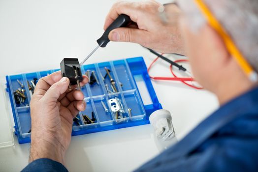 Electrician checking old power plug. Close-up. Selective focus, Focus on power plug. 