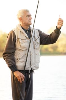 Senior men fishing by the lake.