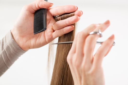 Hairdresser cut hair of a woman.