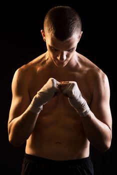 Male fighter is preparing for fight.