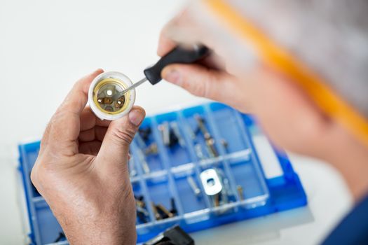 Repairman checking old ceramic bulb socket. Close-up. Selective focus, Focus on socket.