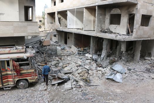 SYRIA, Damascus: A Syrian man walks amid damaged buildings in the Marj al-Sultan neighborhood in eastern Damascus on October 24, 2015.