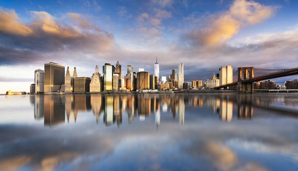 New York City - beautiful sunrise over manhattan with manhattan and brooklyn bridge USA