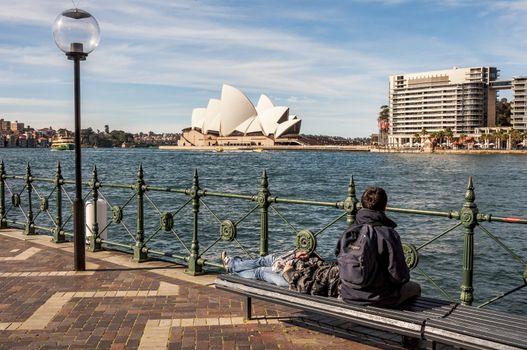 SYDNEY - AUGUST 17: tourist have a rest looking at the Opera House on August 17, 2010 in Sydney, Australia