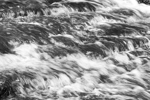 Beautiful background with the moving water of a creek 