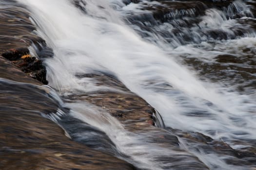 Beautiful waterfalls of a fast creek in fall