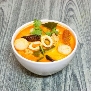 Tom Yum Kung-Thai spicy soup on wood background