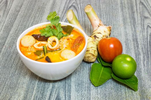 Tom Yum Kung-Thai spicy soup with Herb set of Tom Yum Soup Ingredients on wood background