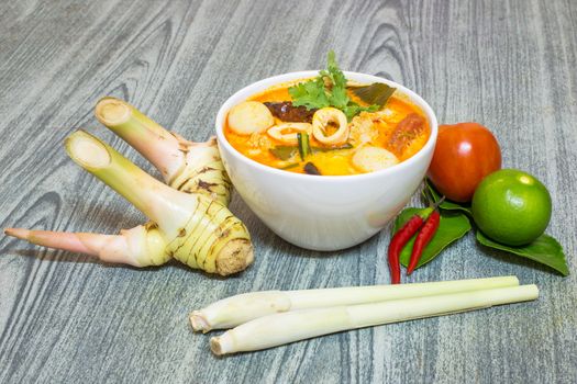 Tom Yum Kung-Thai spicy soup with Herb set of Tom Yum Soup Ingredients on wood background
