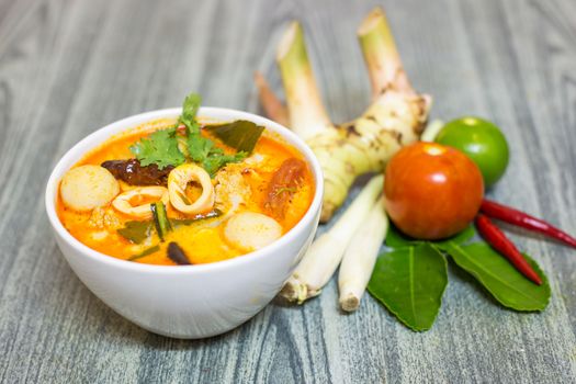 Tom Yum Kung-Thai spicy soup with Herb set of Tom Yum Soup Ingredients on wood background
