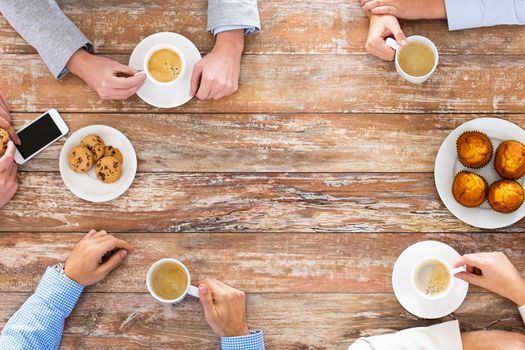 business, people and team work concept - close up of creative team meeting and drinking coffee during lunch in office