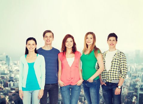 education and people concept - group of smiling students standing